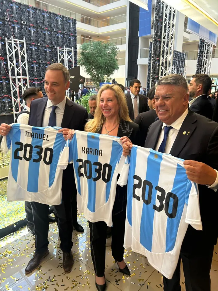 Rodeado. Manuel Adorni, Karina Milei y Chiqui Tapia, con la camiseta del Mundial 2030.