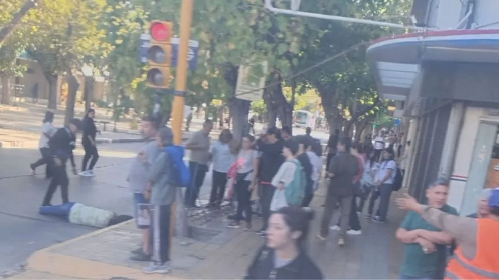La mujer, tirada en el asfalto, frente a un reconocido comercio de venta de bicicletas.